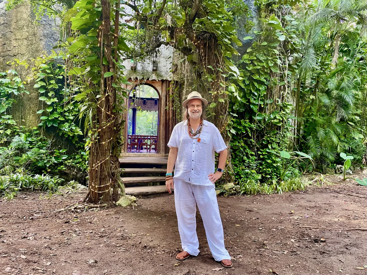 Christopher Sherrod standing in a lush garden